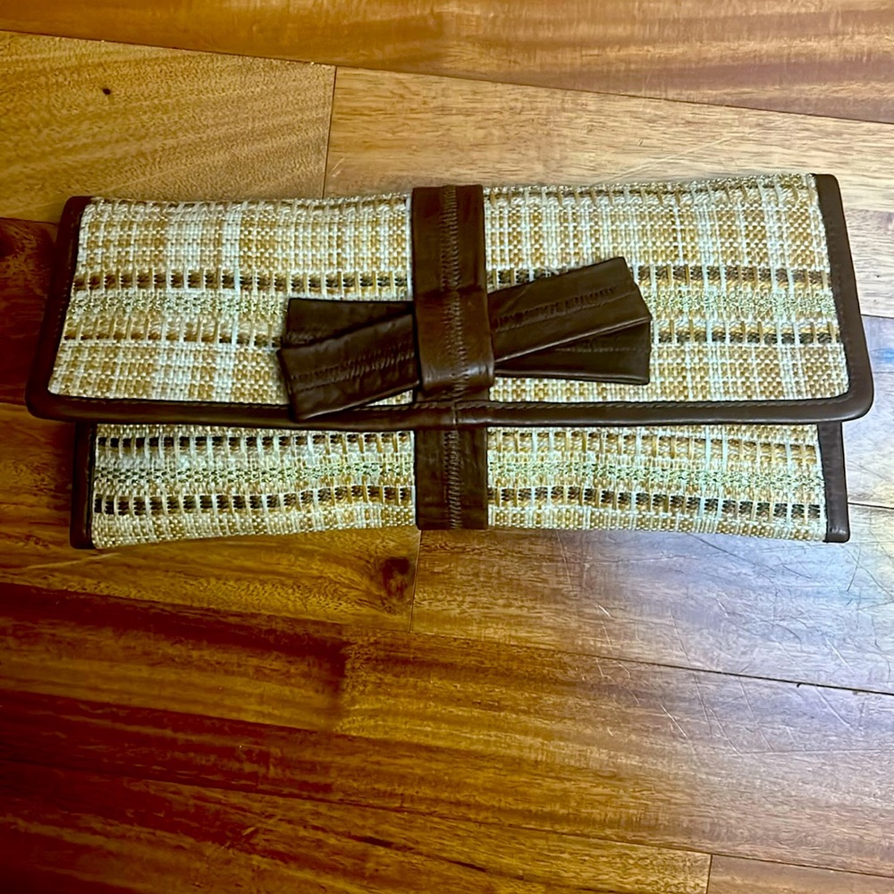 Franchi- tweed clutch with brown leather trim with bow.